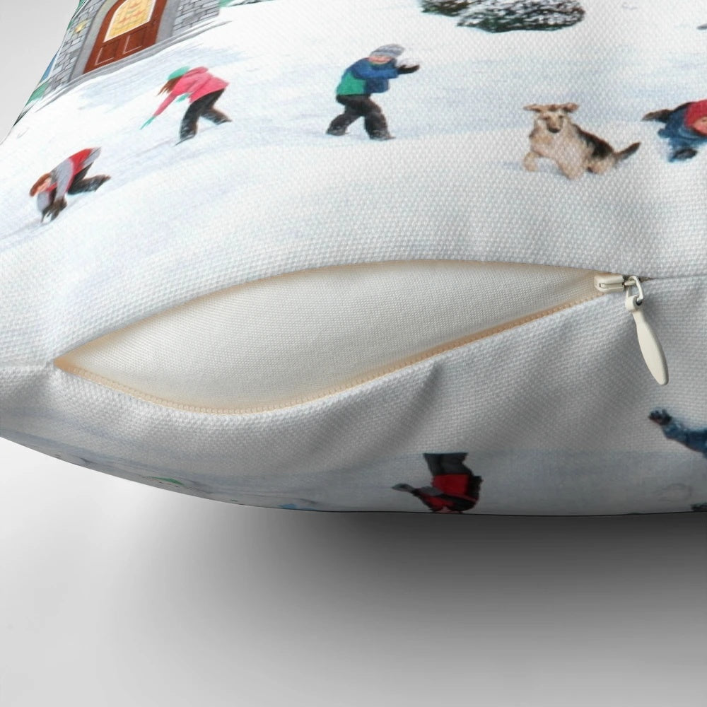 A soft, plush pillow featuring a winter scene with a snowman, trees, and a house in the snow.