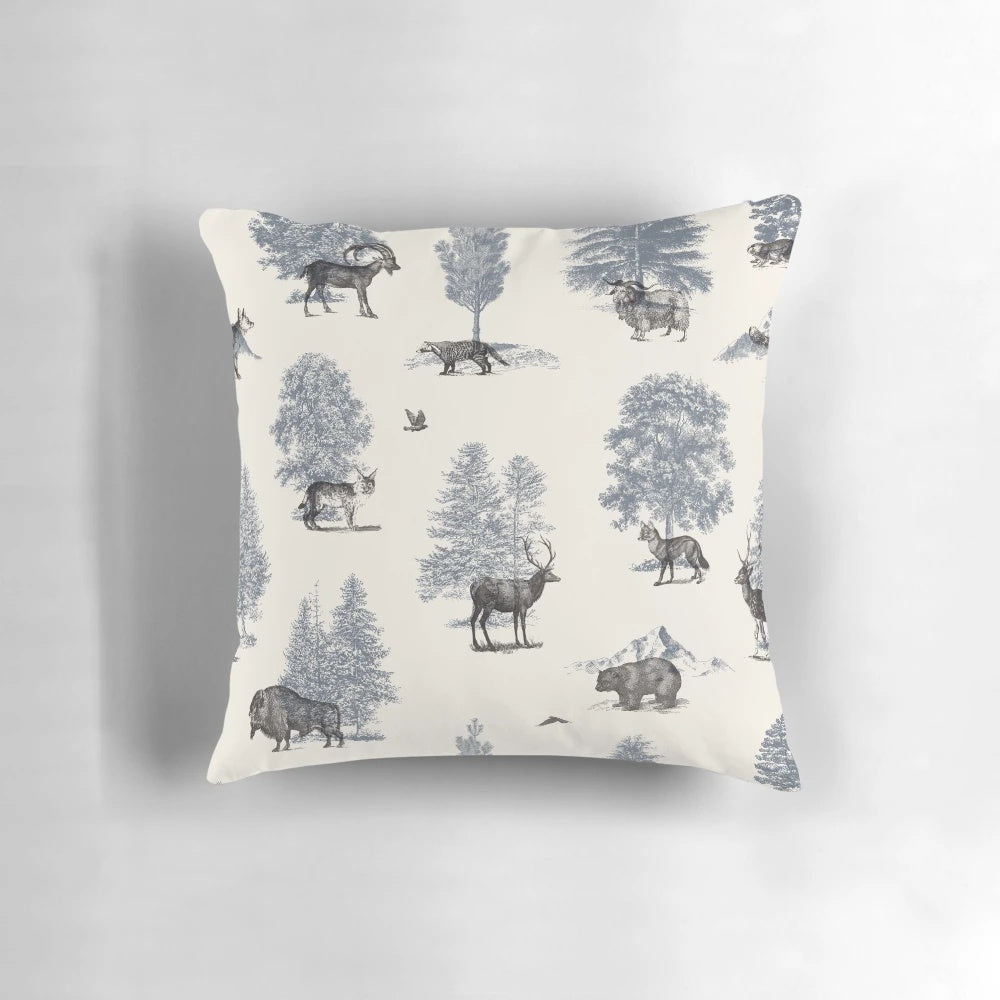 Decorative winter pillow featuring an illustration of woodland animals like foxes, bears, and birds in a snowy forest scene.