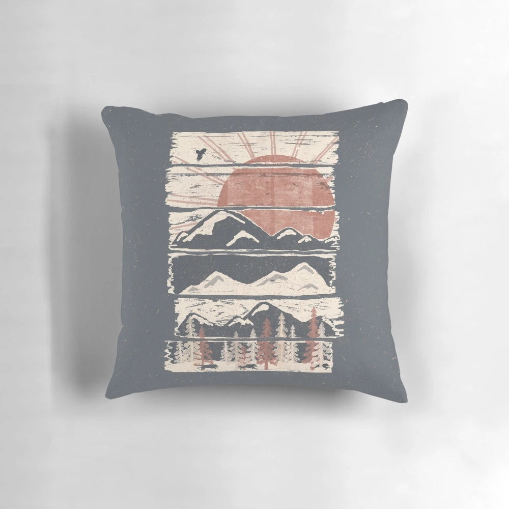 Pillow with a scenic winter landscape design featuring mountains, trees, and wildlife.