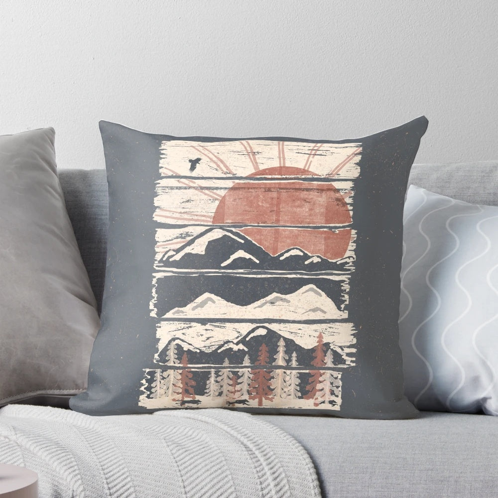 Pillow with a scenic winter landscape design featuring mountains, trees, and wildlife.