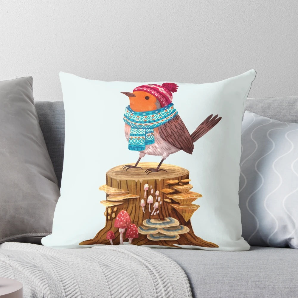 Cozy winter pillow featuring a robin bird in a scarf and hat, surrounded by mushrooms and trees.