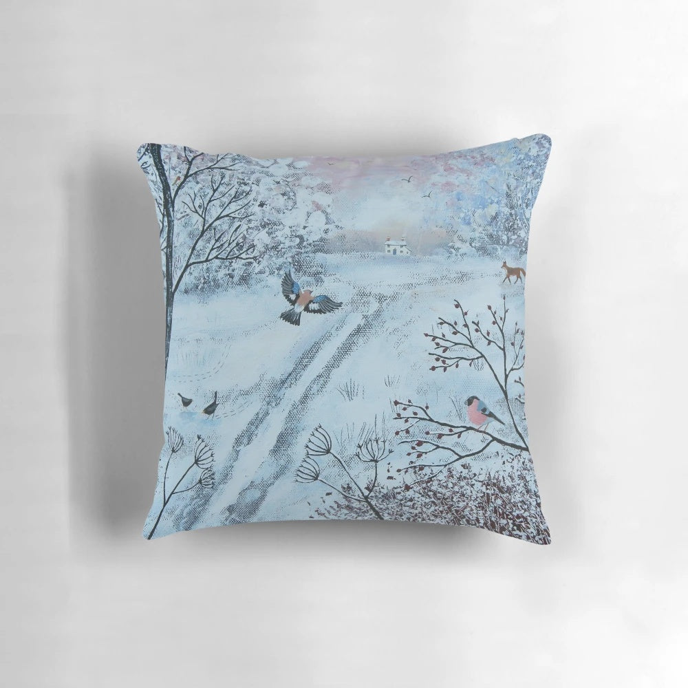 A soft, plush pillow featuring a peaceful winter landscape with birds and snow-covered trees.