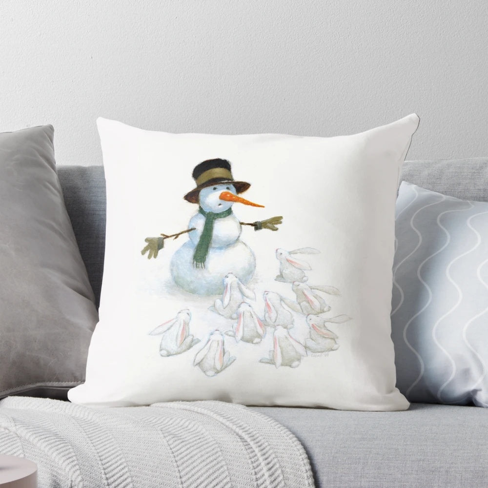 A white snowman with a carrot nose facing a group of hungry white bunnies on a soft, plush pillow.