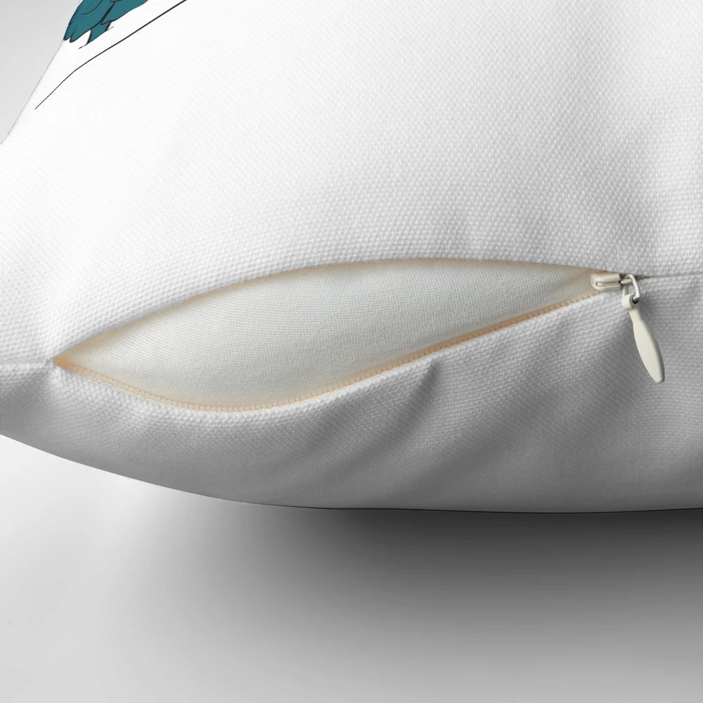 A plush, decorative pillow featuring a winter sports scene with snow-covered hills and skiers.