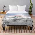 Plush blanket featuring a winter wolf design with a teal galaxy night sky