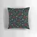 A plush, soft throw pillow with a winter nature design featuring berries, leaves, and snowflakes against a dark background.