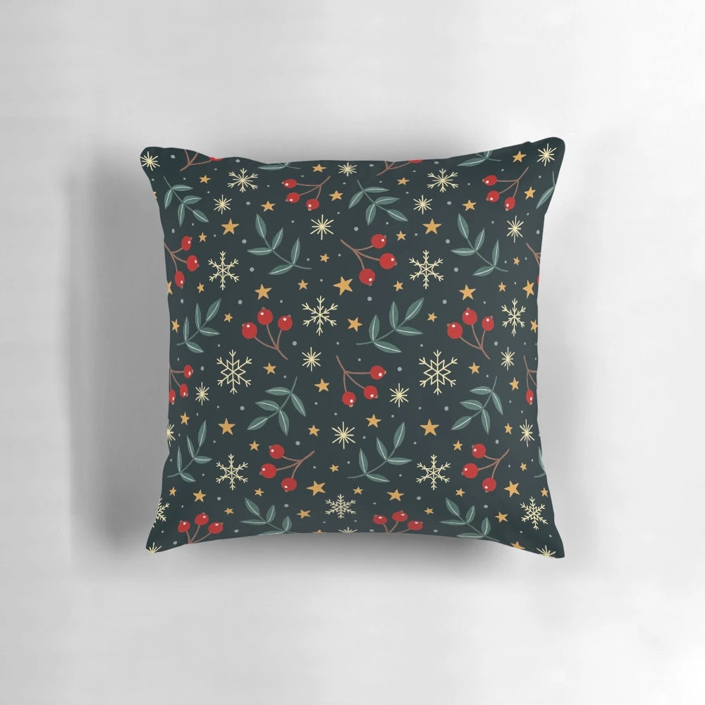 A plush, soft throw pillow with a winter nature design featuring berries, leaves, and snowflakes against a dark background.