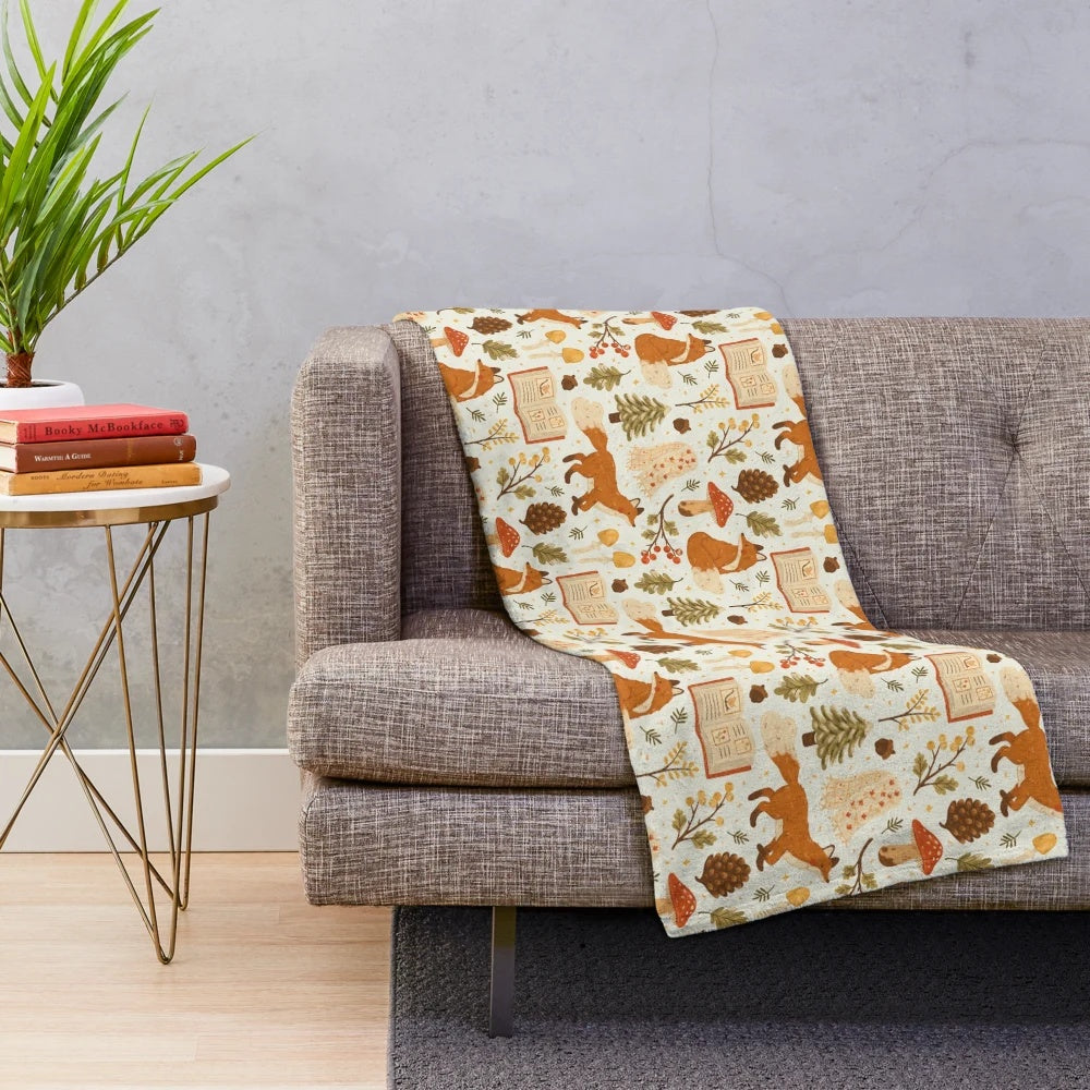 Cozy winter woodland plush blanket with forest animal and botanical design