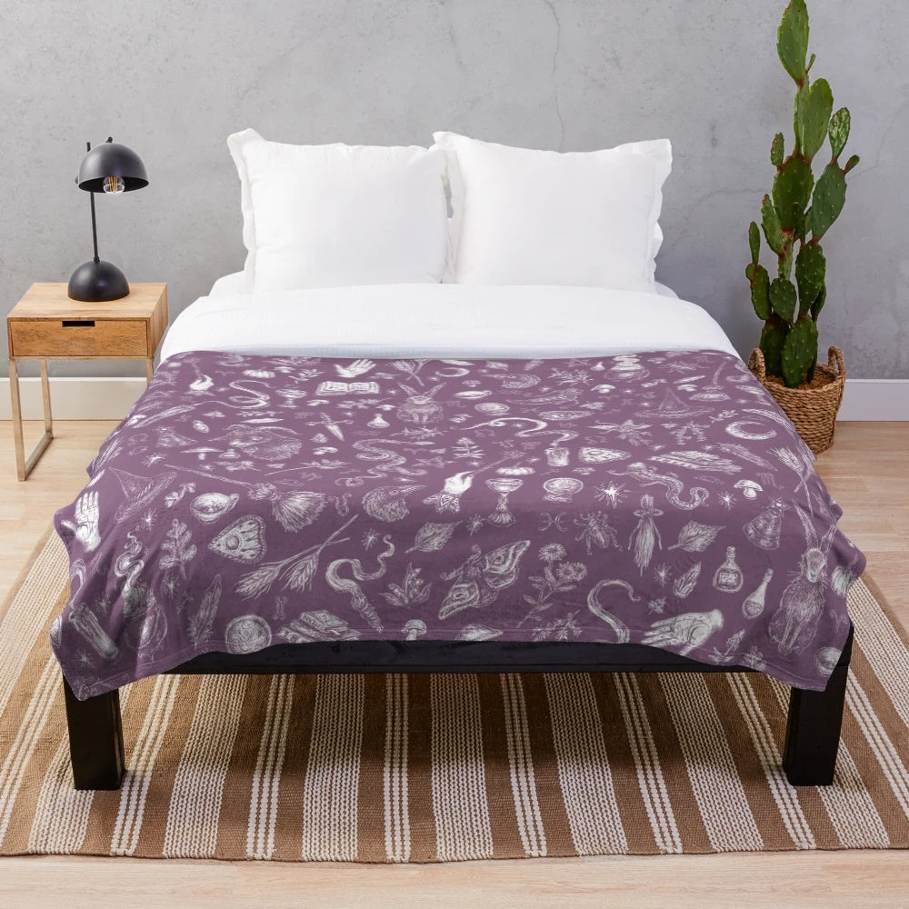Purple plush blanket with witch design, perfect for Halloween