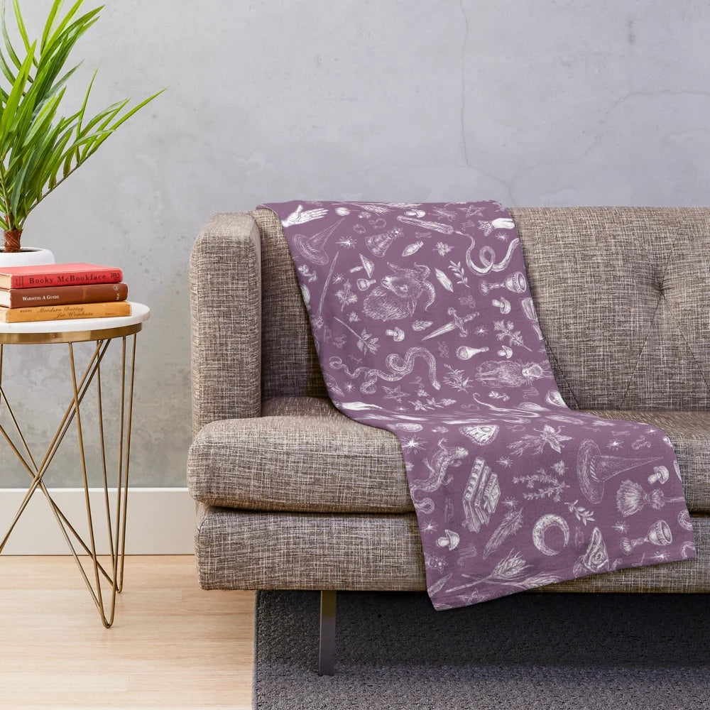 Purple plush blanket with witch design, perfect for Halloween