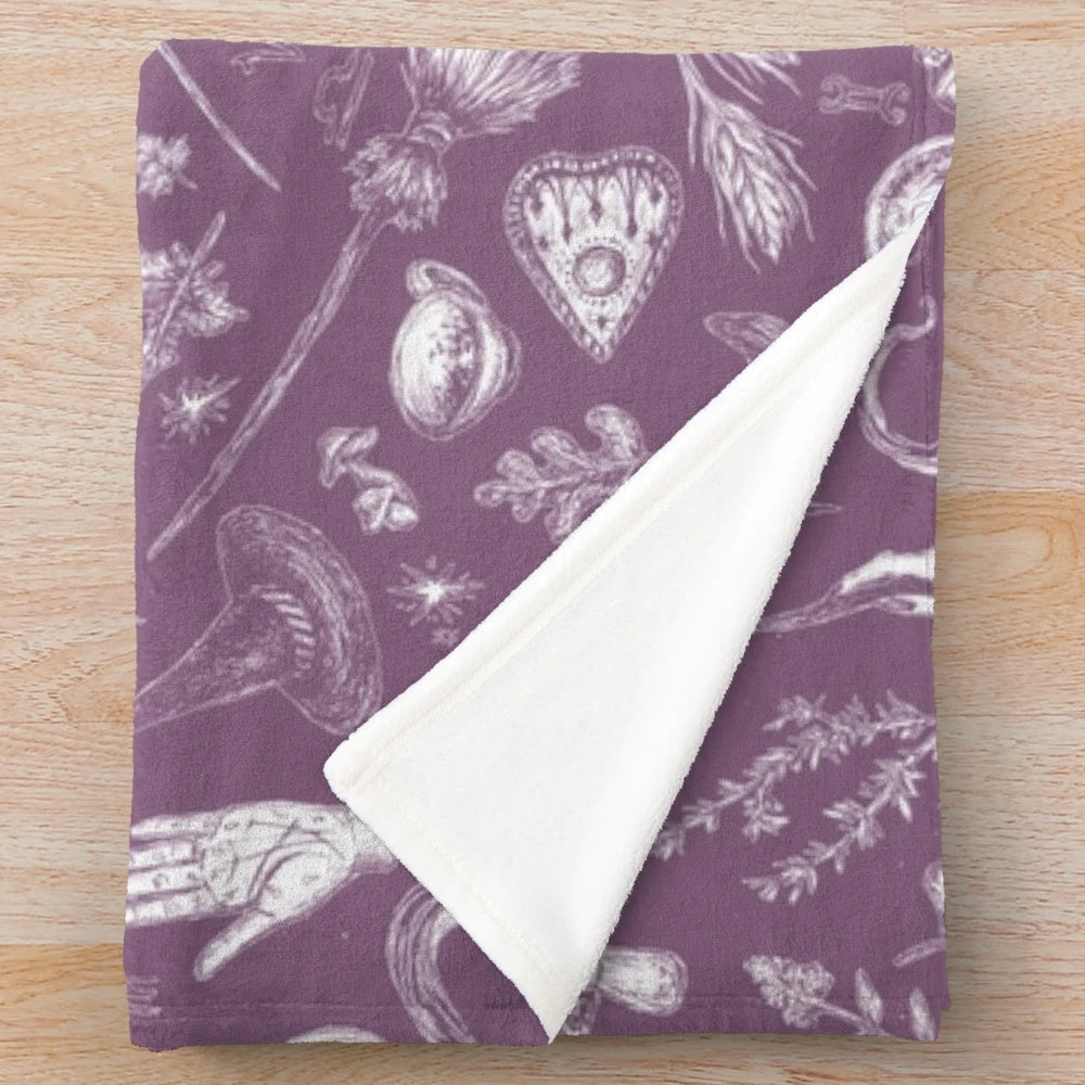 Purple plush blanket with witch design, perfect for Halloween