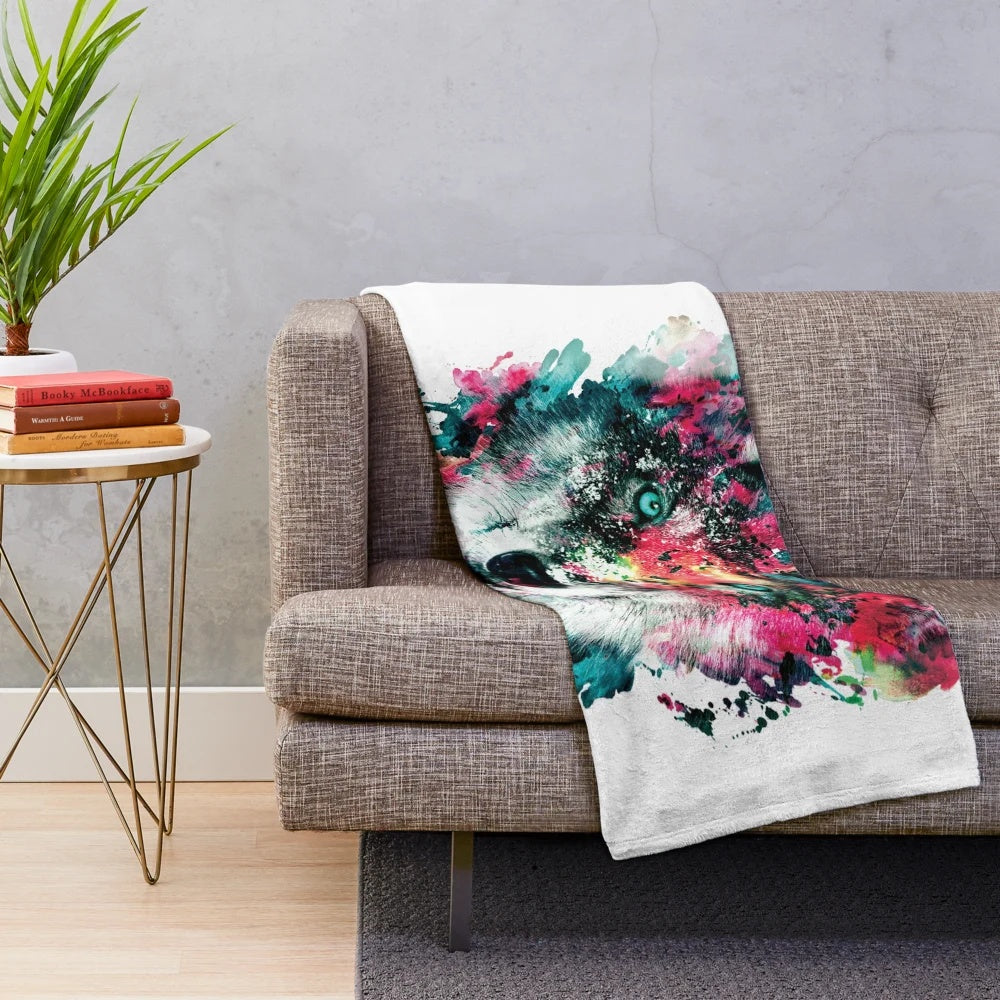 Colorful abstract wolf face design on a plush and cozy blanket