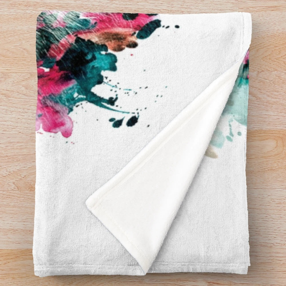 Colorful abstract wolf face design on a plush and cozy blanket
