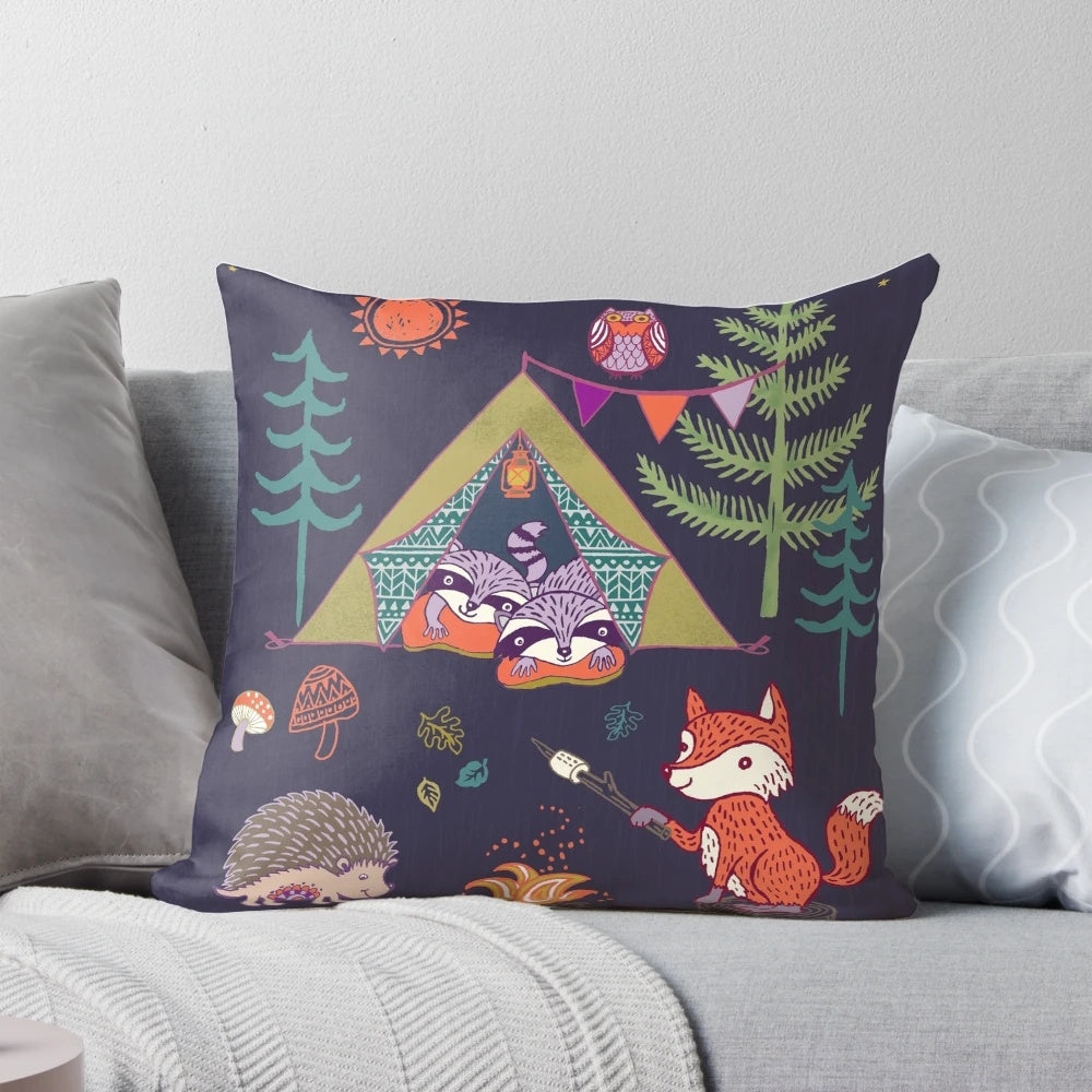 A plush pillow featuring a whimsical design of woodland animals like foxes, hedgehogs, and owls in a camping scene.