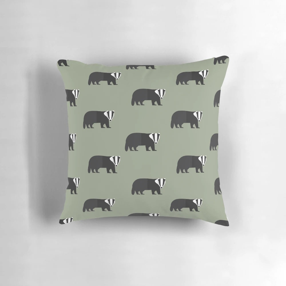 A decorative pillow featuring a whimsical black and white badger design on a green background, perfect for adding a touch of nature to any room.