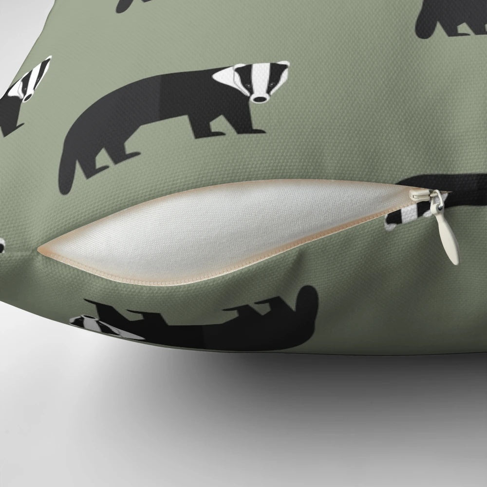 A decorative pillow featuring a whimsical black and white badger design on a green background, perfect for adding a touch of nature to any room.