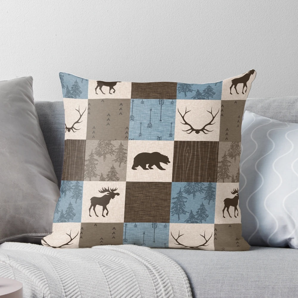 Decorative blue, brown, and beige patchwork pillow with woodland animal designs