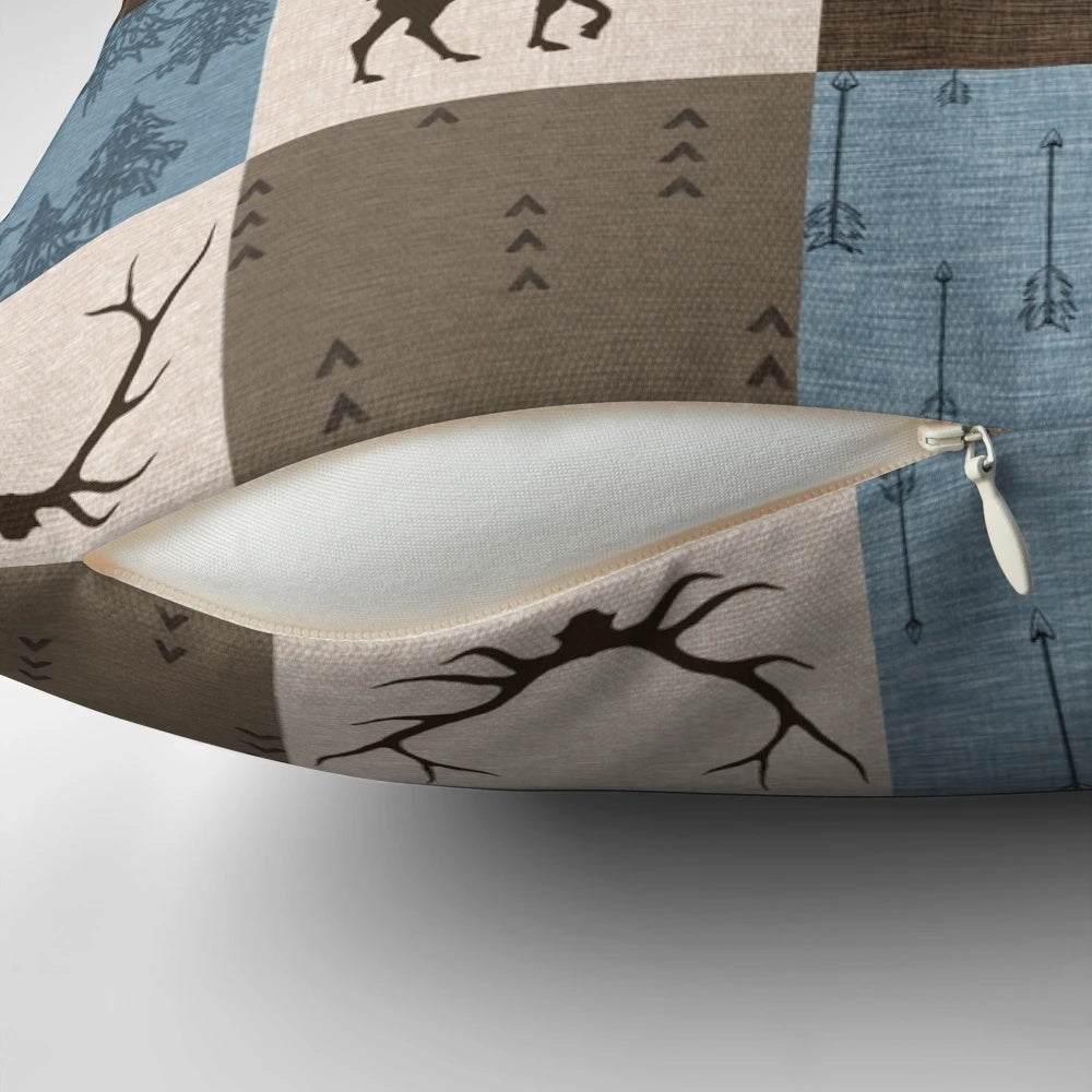 Decorative blue, brown, and beige patchwork pillow with woodland animal designs