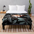 Plush blanket with nature-inspired animals and foliage