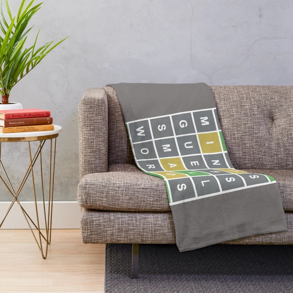 Wordle-themed plush blanket with green, yellow, and grey squares
