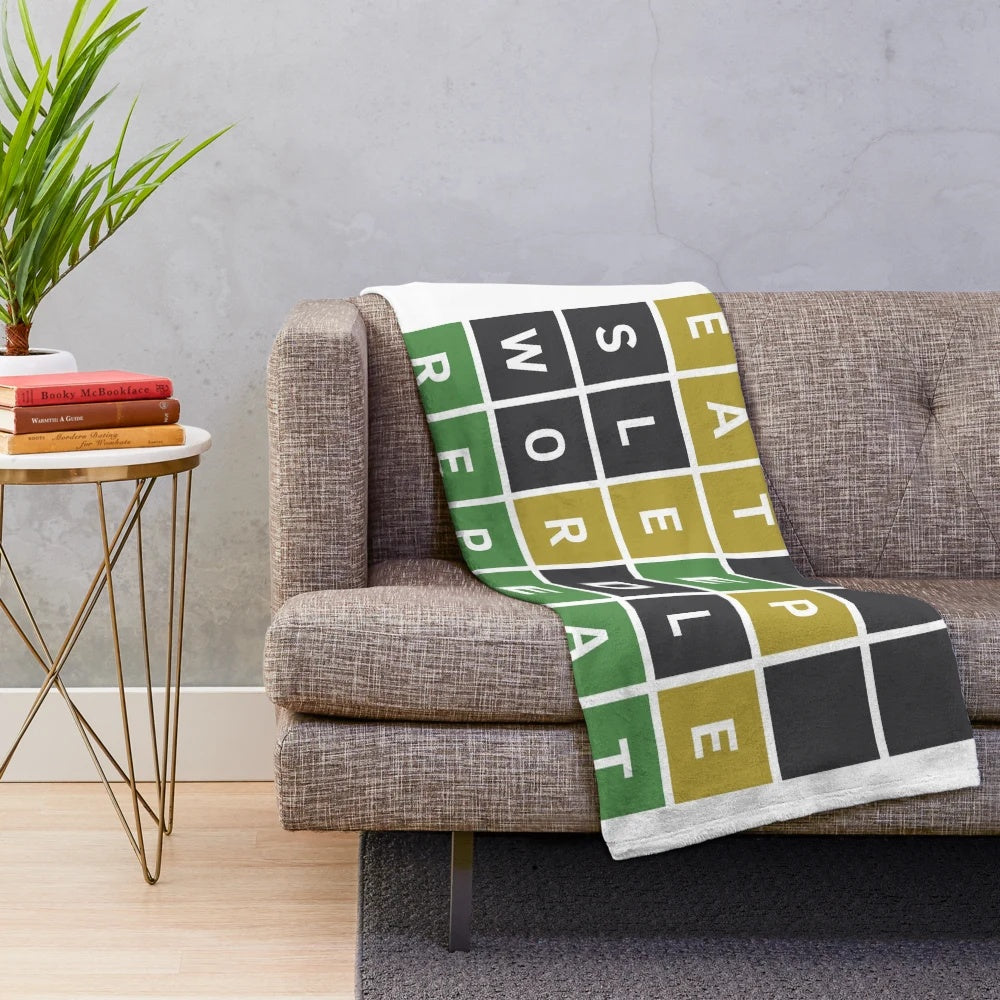 Wordle-themed plush blanket with green, yellow, and gray squares