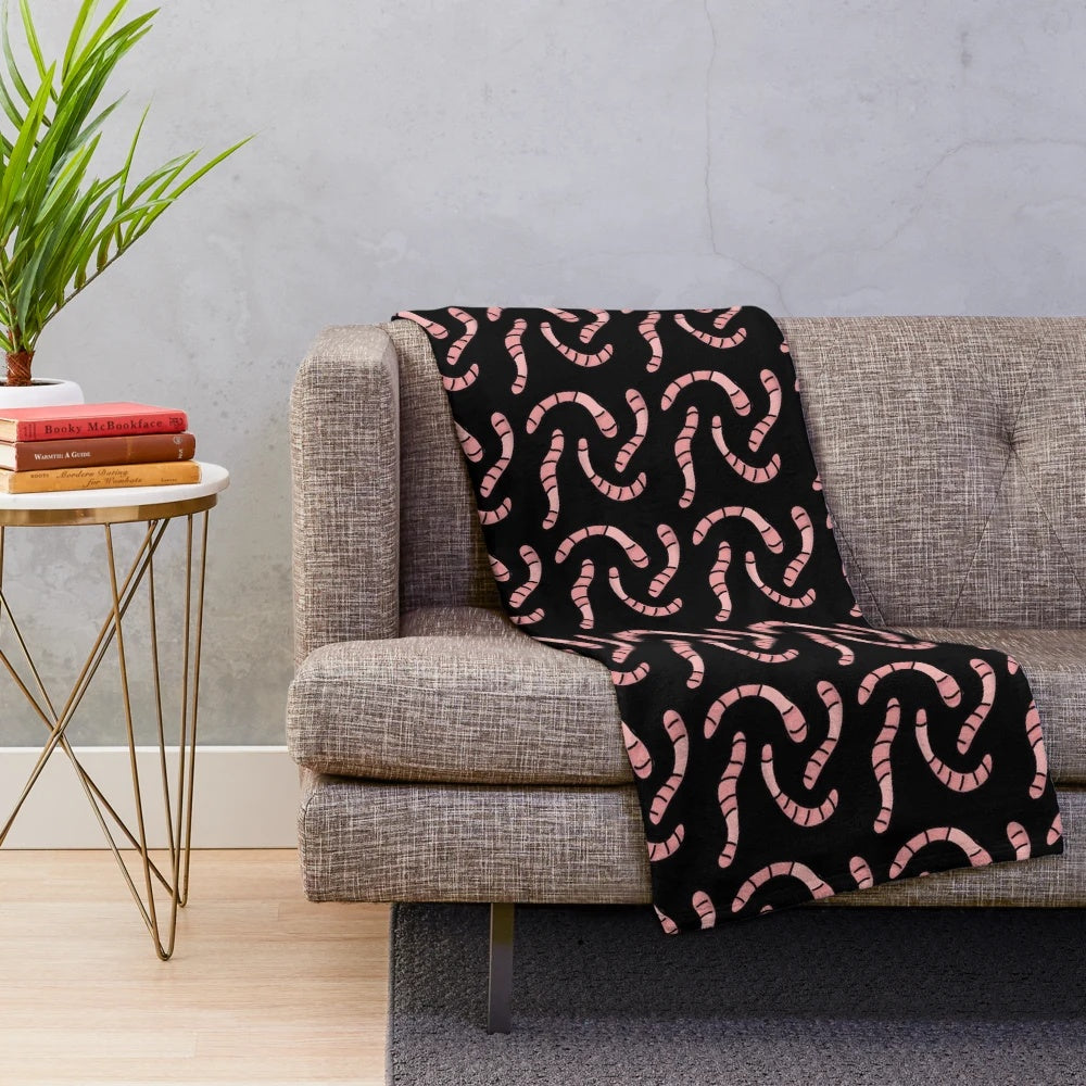 Soft and cuddly plush blanket with a worm design