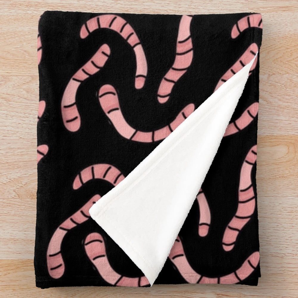 Soft and cuddly plush blanket with a worm design