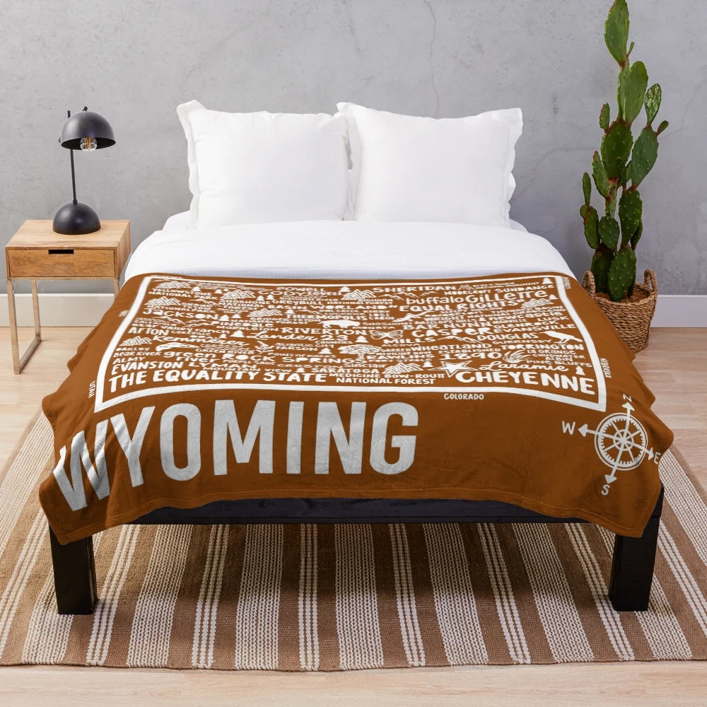 Wyoming map plush blanket featuring the outline and key landmarks of the Equality State