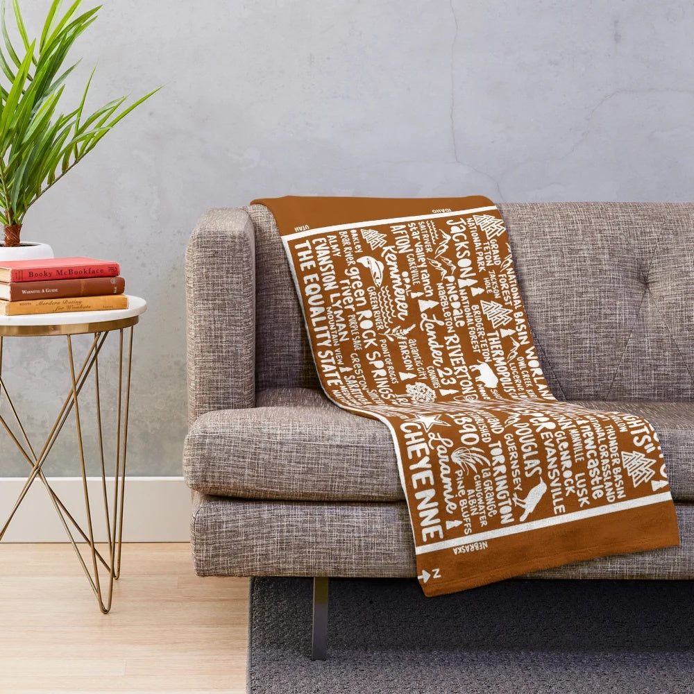 Wyoming map plush blanket featuring the outline and key landmarks of the Equality State