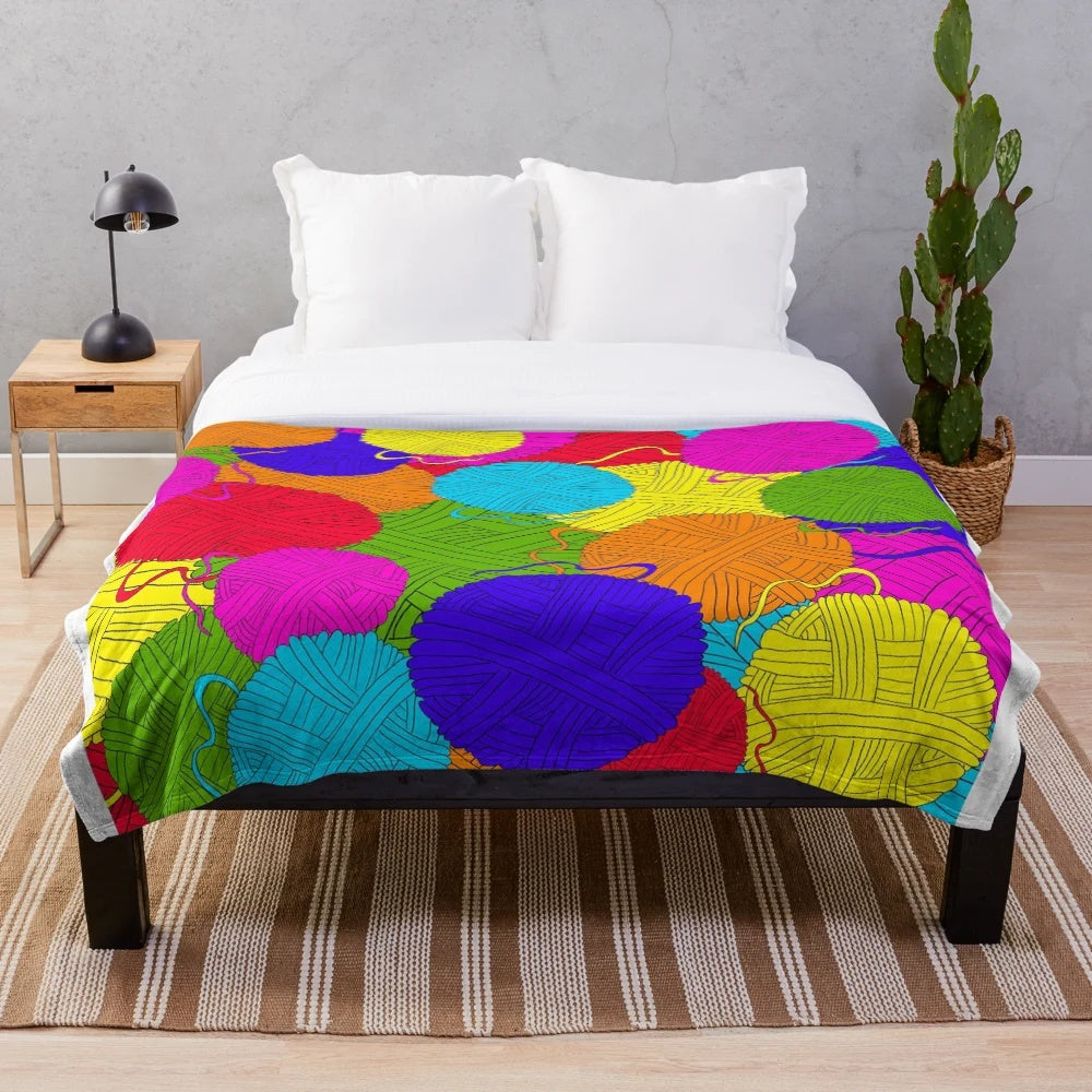 Colorful plush blanket featuring a playful design of yarn balls