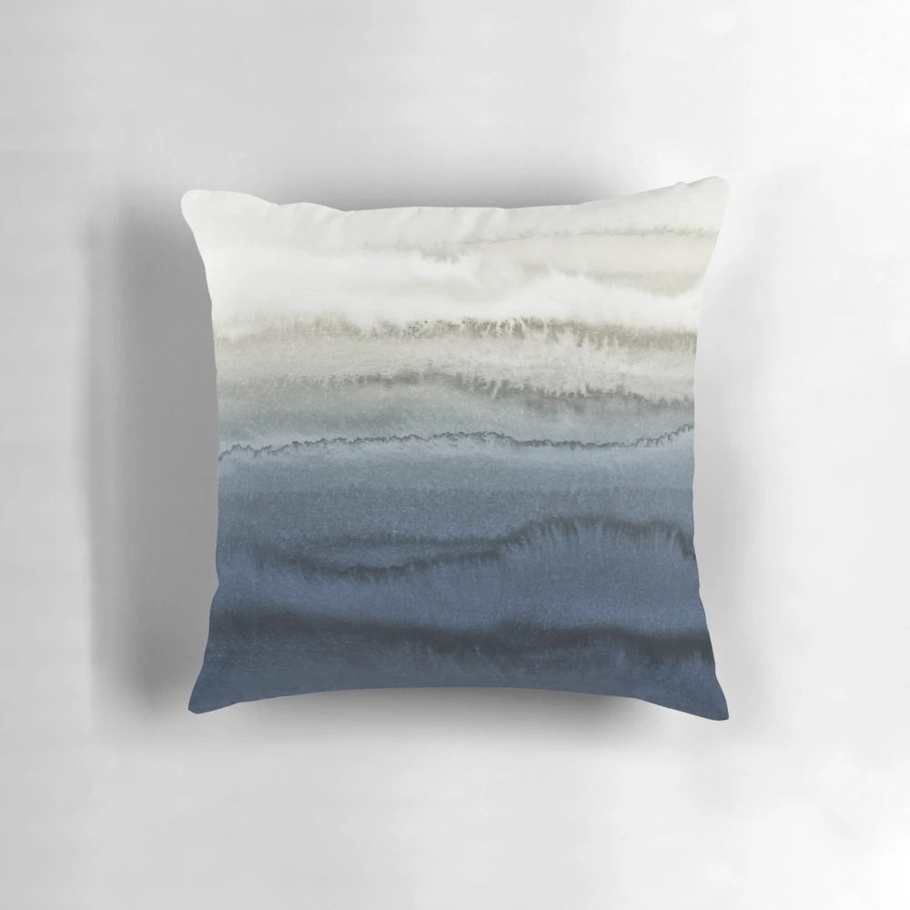 Crashing waves in a blue watercolor landscape design on a decorative pillow