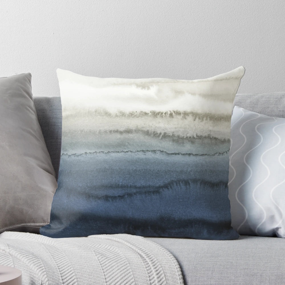 Crashing waves in a blue watercolor landscape design on a decorative pillow