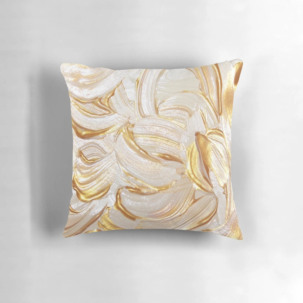 Cream and gold decorative pillow with abstract brush stroke design