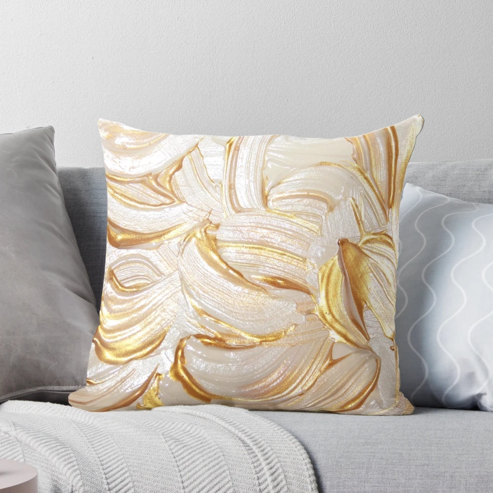 Cream and gold decorative pillow with abstract brush stroke design