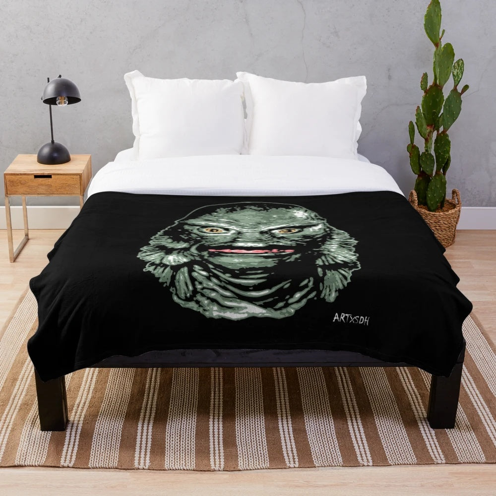 Creature from the Black Lagoon-inspired plush blanket featuring classic horror movie imagery