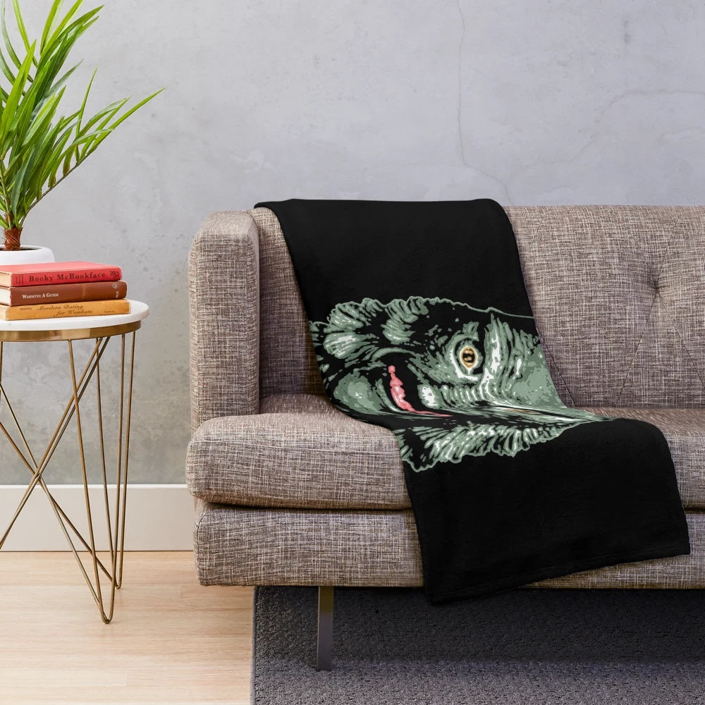 Creature from the Black Lagoon-inspired plush blanket featuring classic horror movie imagery