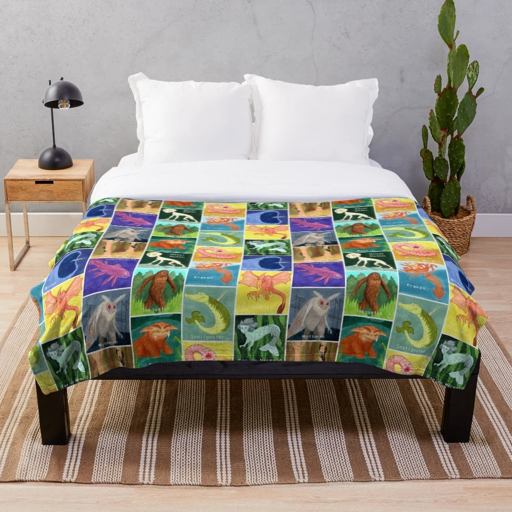 Creepy cute cryptid plush blanket featuring a variety of mysterious creatures