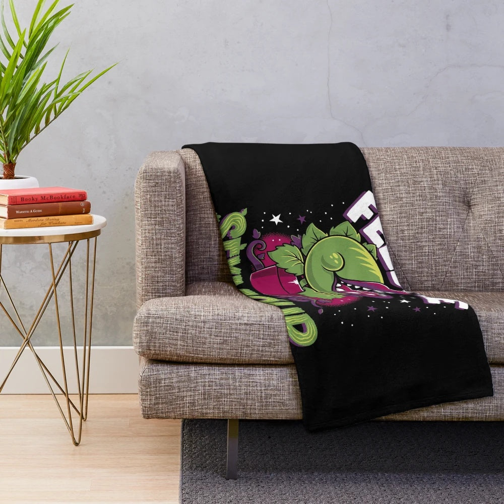 Creepy cute horror plush blanket featuring an Audrey plant inspired design