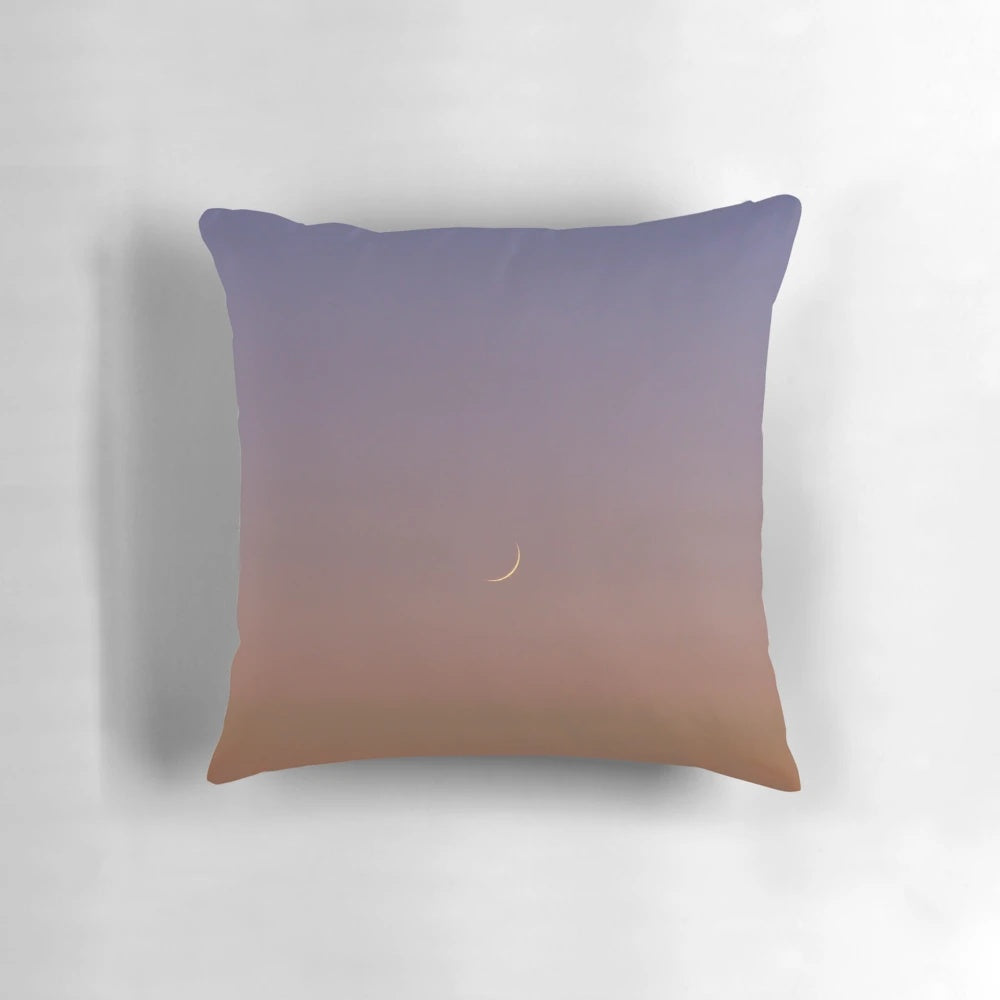 Decorative crescent moon throw pillow with sunset sky background