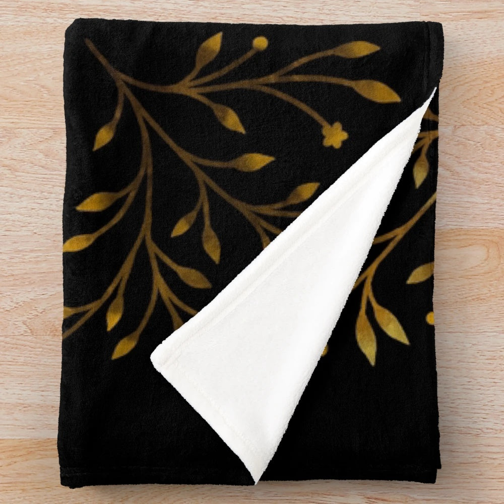 Crescent moon themed gold plush blanket with botanical floral design