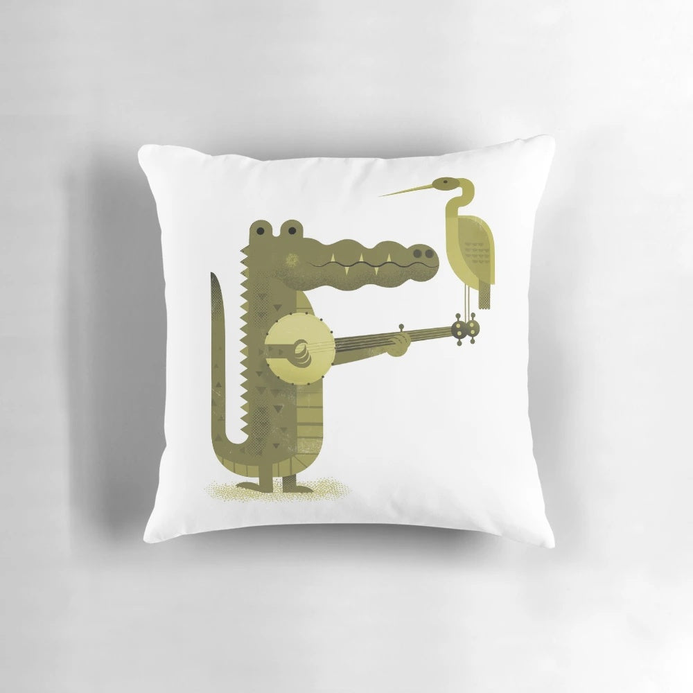 A decorative throw pillow featuring a vibrant digital art design of a crocodile and stork in a nature-inspired landscape.