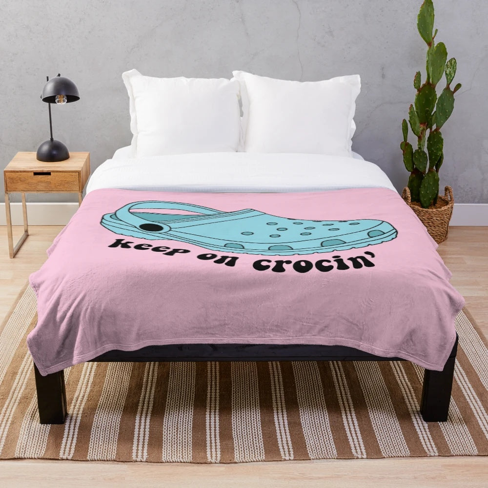 Croc-inspired plush blanket with "Keep On Crockin'" design