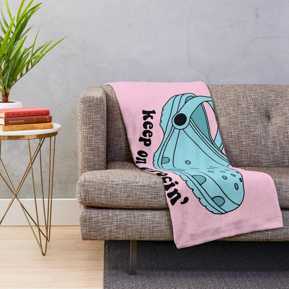 Croc-inspired plush blanket with "Keep On Crockin'" design