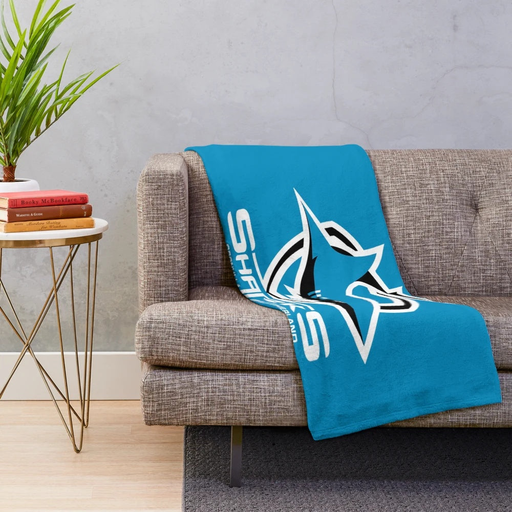 Cronulla Sutherland Sharks inspired plush blanket featuring a white shark design on a shield