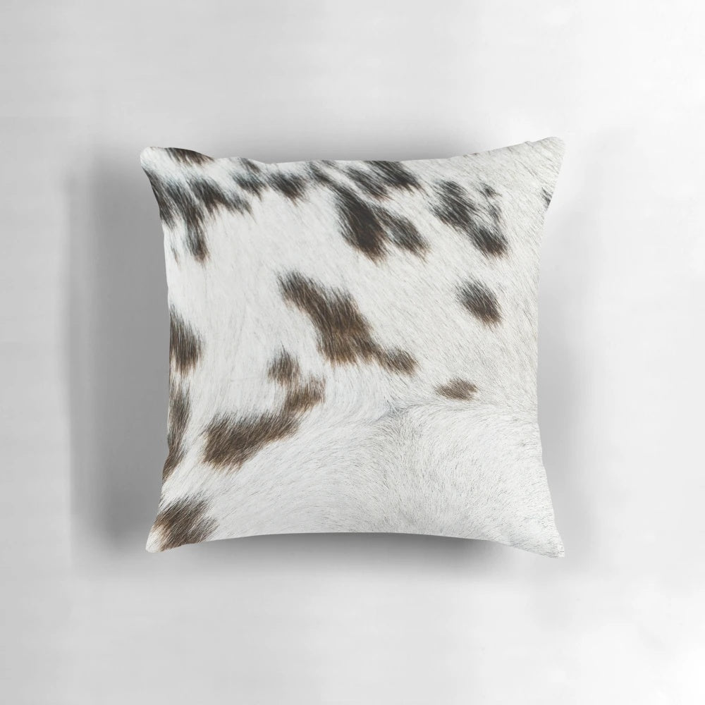 Cruelty-free cowhide pillow in tan, black, and white colors for natural, rustic farmhouse decor