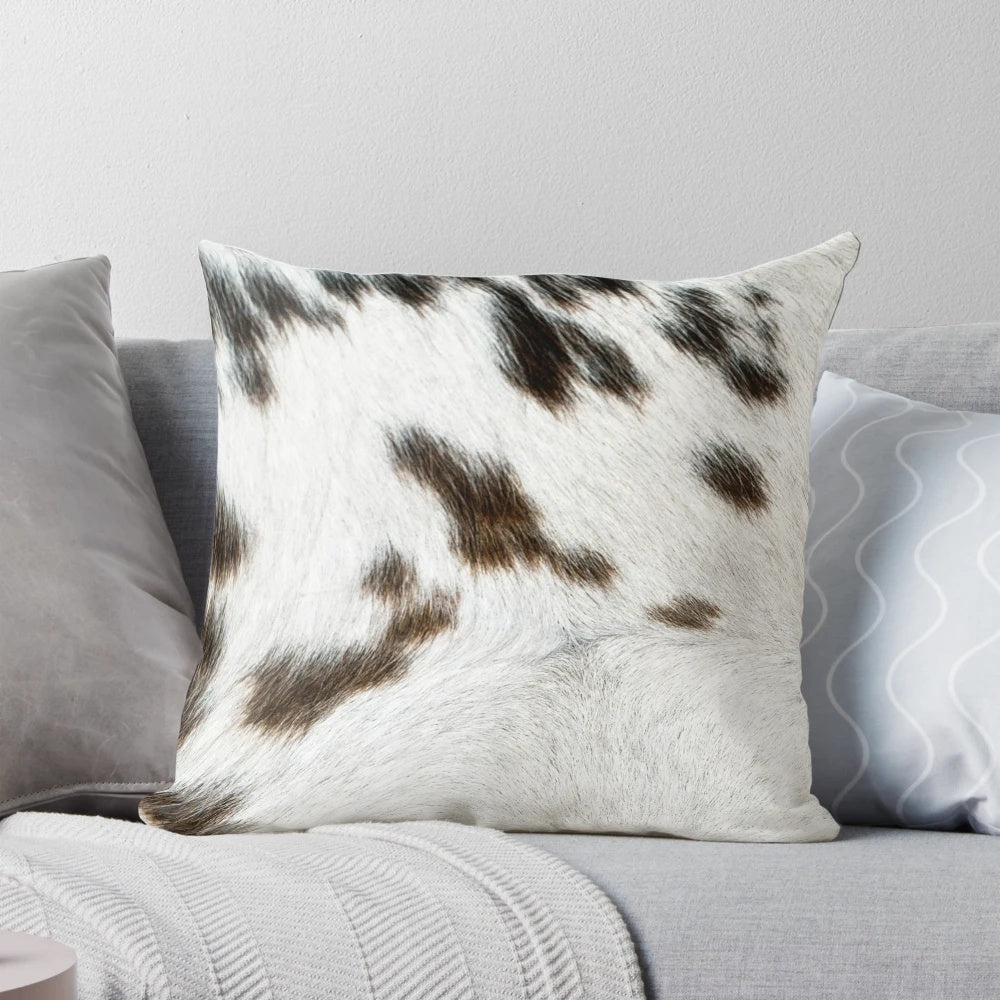 Cruelty-free cowhide pillow in tan, black, and white colors for natural, rustic farmhouse decor