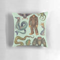 Decorative pillow featuring illustrations of legendary cryptid creatures from the Americas