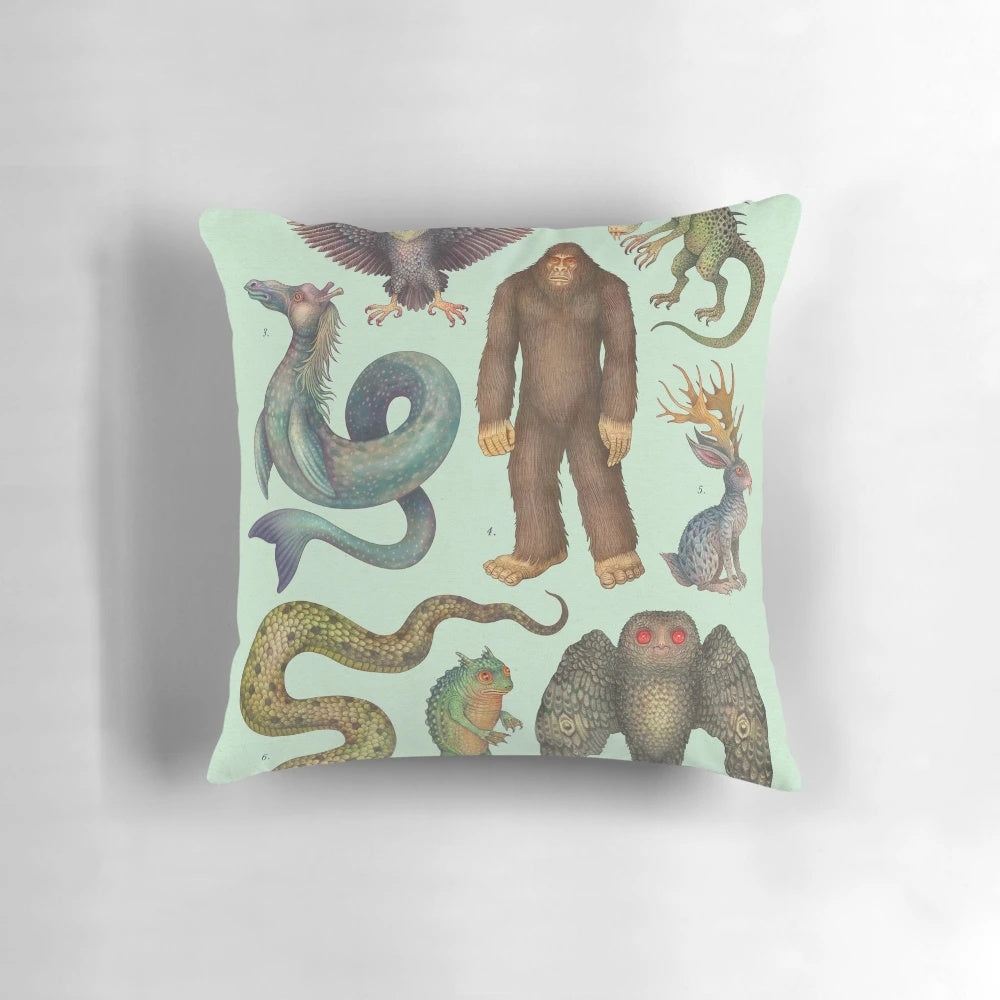 Decorative pillow featuring illustrations of legendary cryptid creatures from the Americas