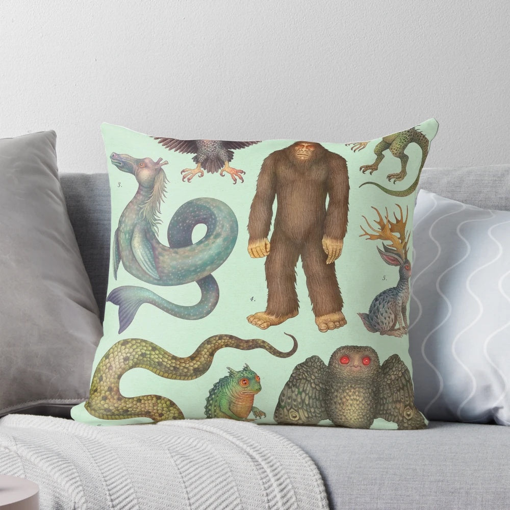 Decorative pillow featuring illustrations of legendary cryptid creatures from the Americas