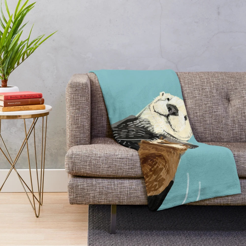 Soft and cozy plush blanket featuring an adorable Alaska sea otter mother and her baby